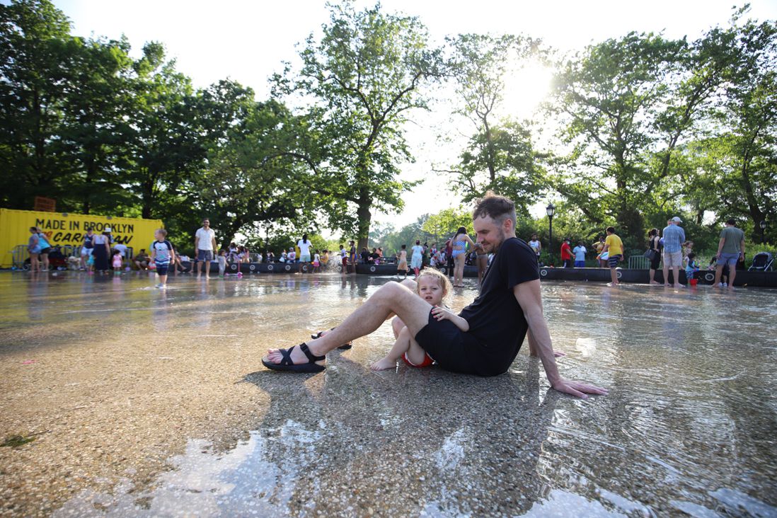 A photo of people hanging out at the Prospect Park Splash Pad